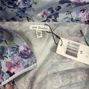 Vera Bradley light weight rain jacket with storable rain hood.